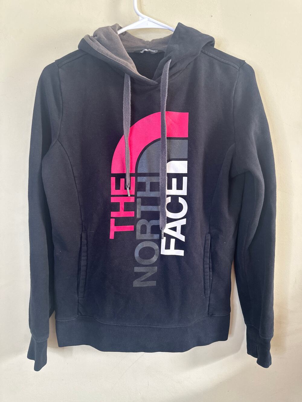 The North Face Fave Pullover Hoodie with a pink and white graphic logo S Y